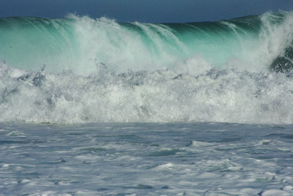 a man riding a wave on top of a surfboard