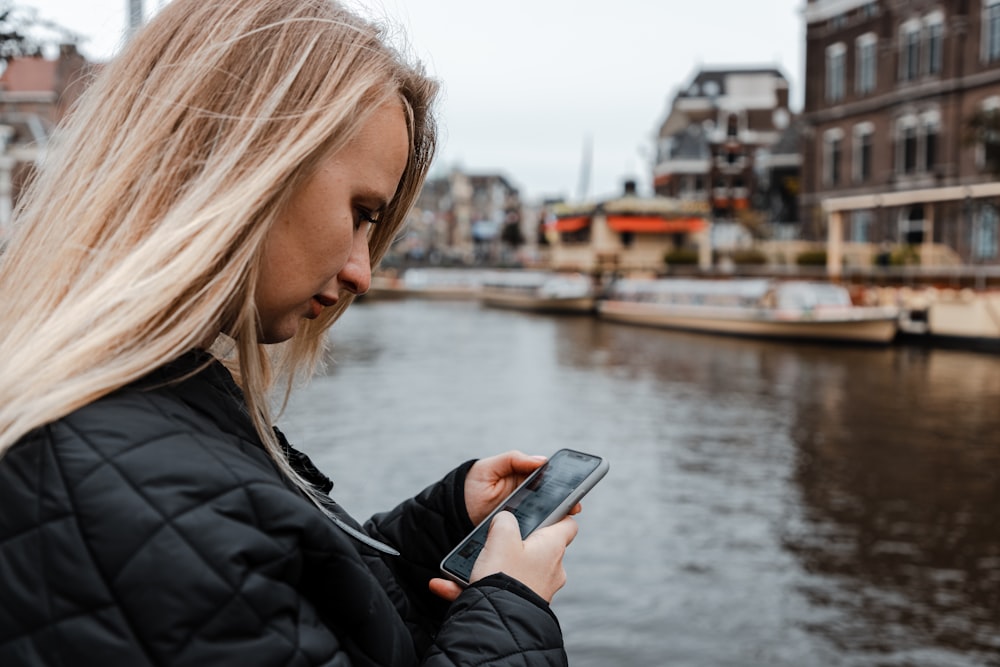 a woman is looking at her cell phone