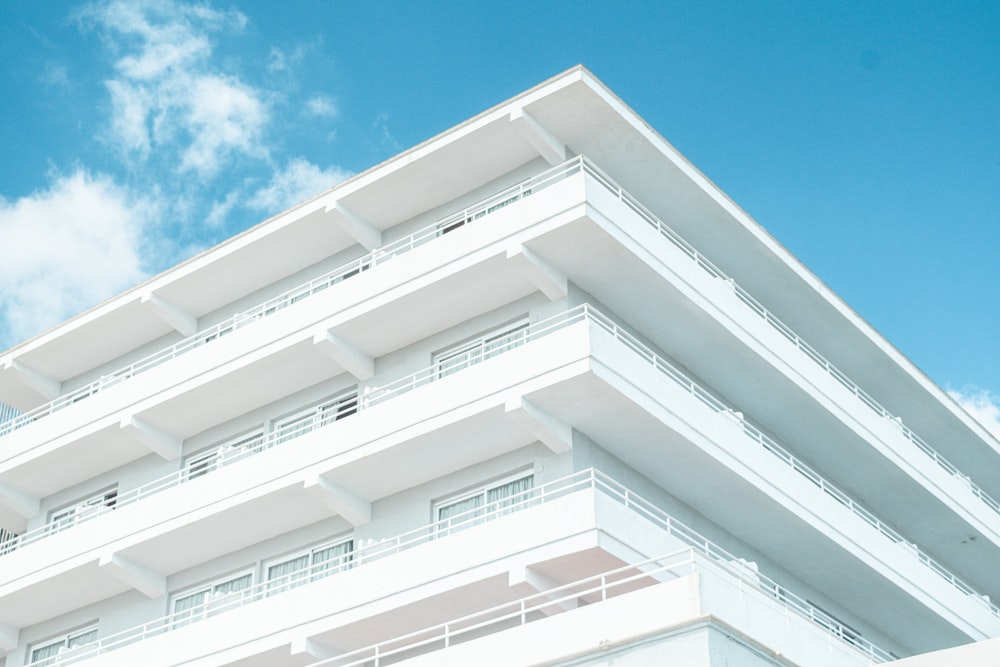 a tall white building with balconies and balconies