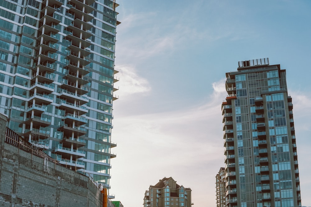 a couple of tall buildings sitting next to each other