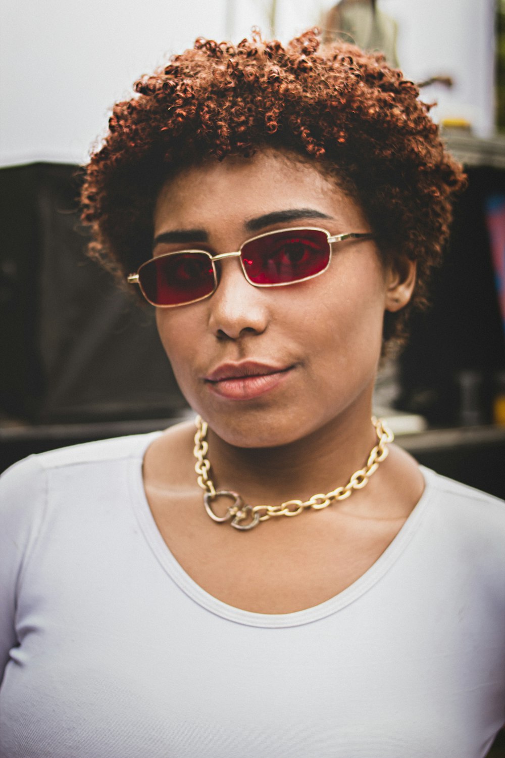 a woman wearing sunglasses and a necklace