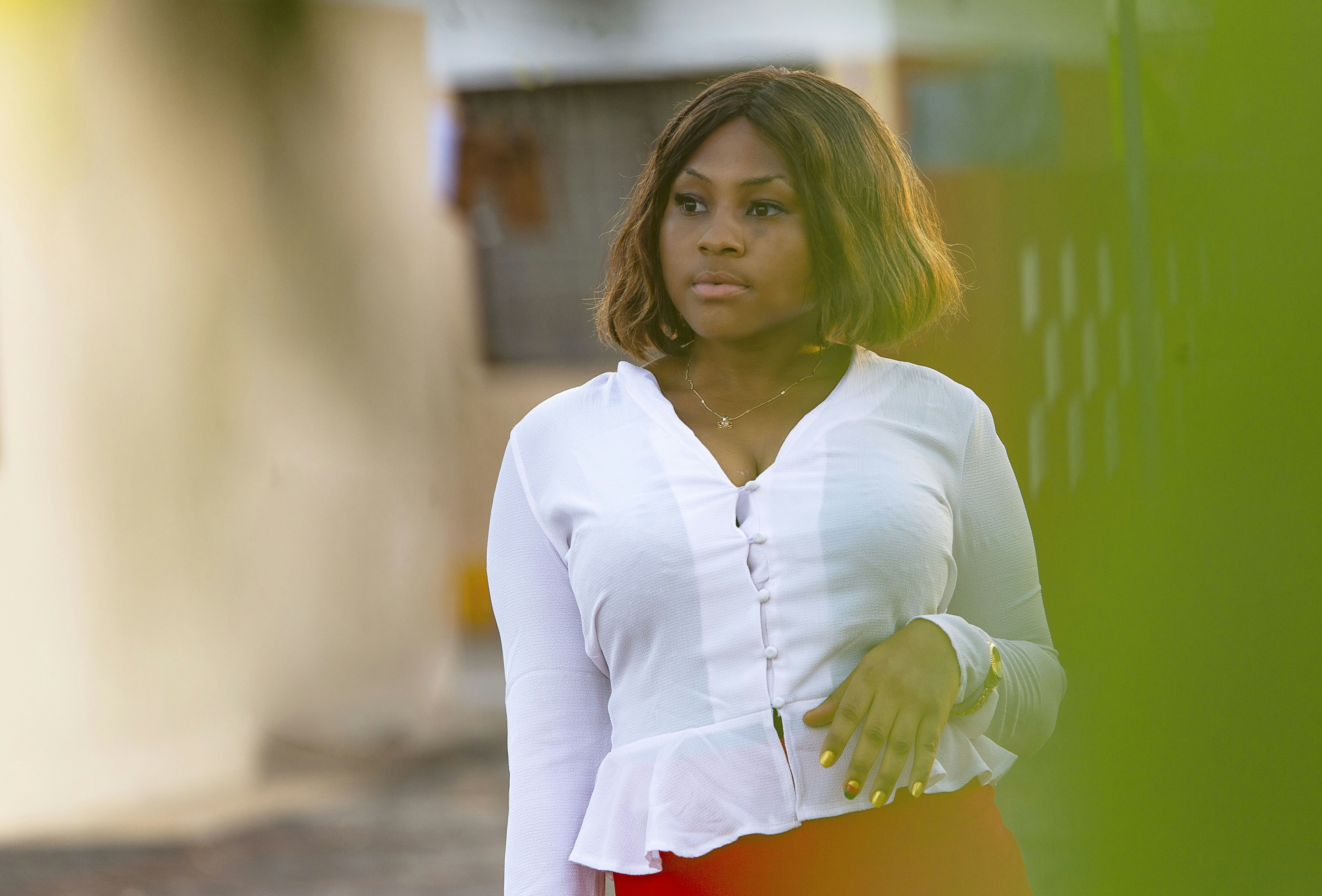 a woman in a white shirt and red skirt