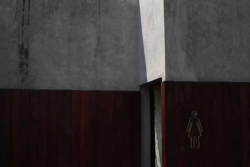 a bathroom door with a sign on the side of it