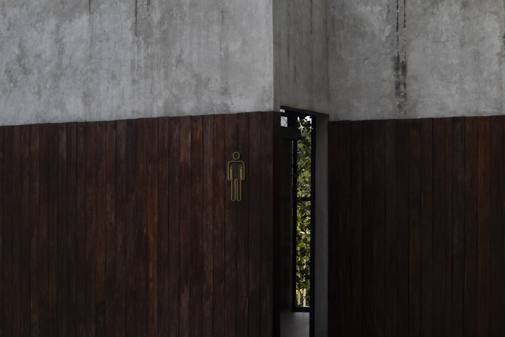 a wooden door is open in a concrete building