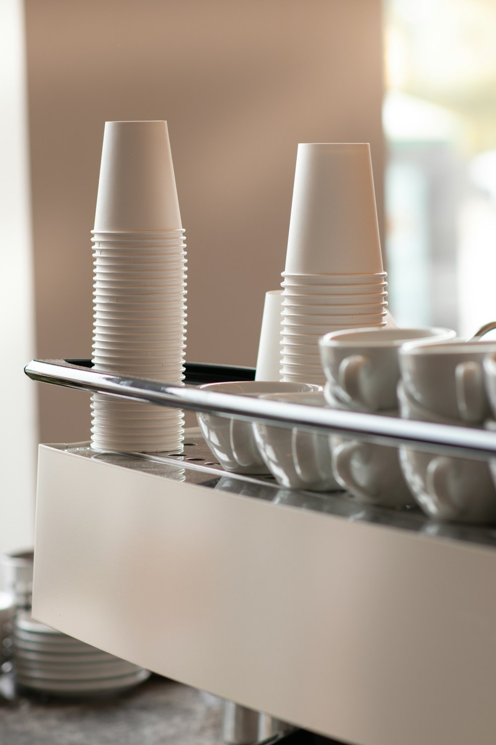 a row of white cups sitting on top of a counter