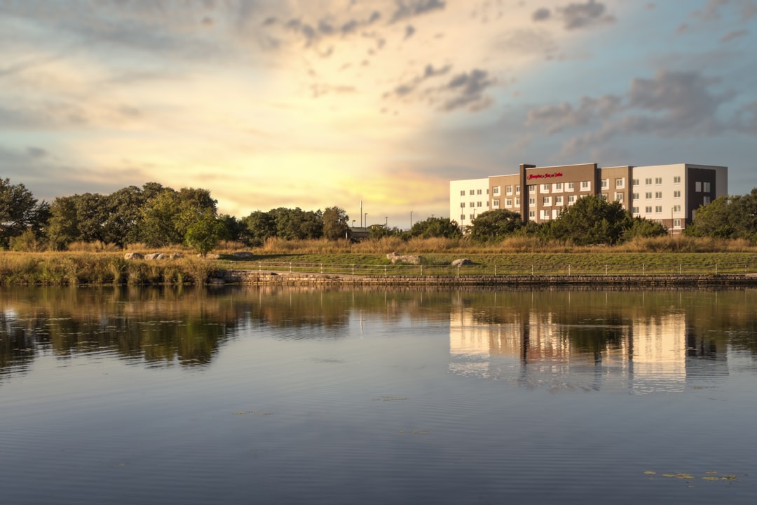 a body of water with a building in the background,