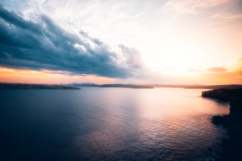 a large body of water under a cloudy sky