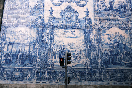 A lively street art piece combining traditional Portuguese patterns with modern themes.