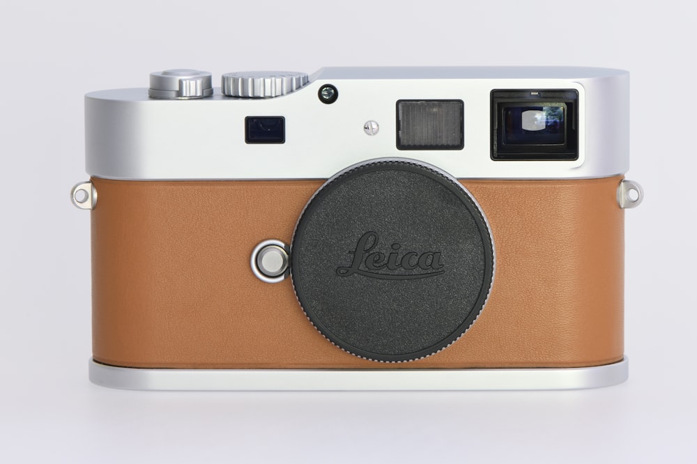 a brown and white camera sitting on top of a table