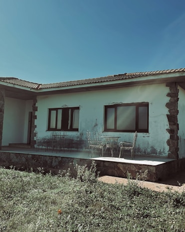 Front view of a beautifully remodeled Florida home with fresh tile installation and manicured garden.