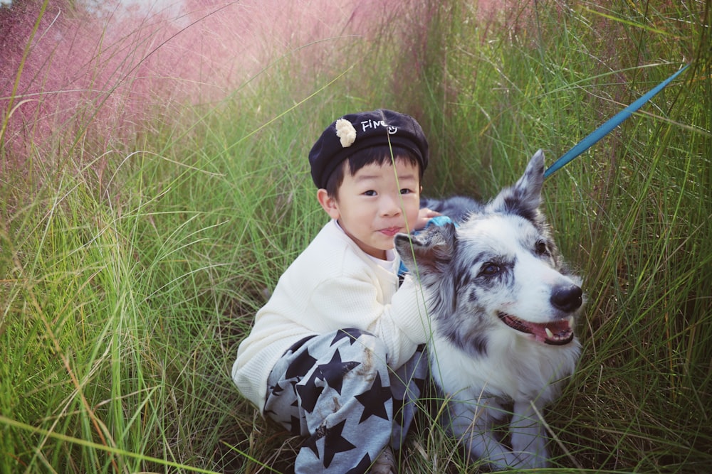 a little boy holding a dog