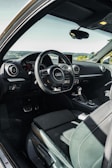 the interior of a car with a steering wheel and dashboard