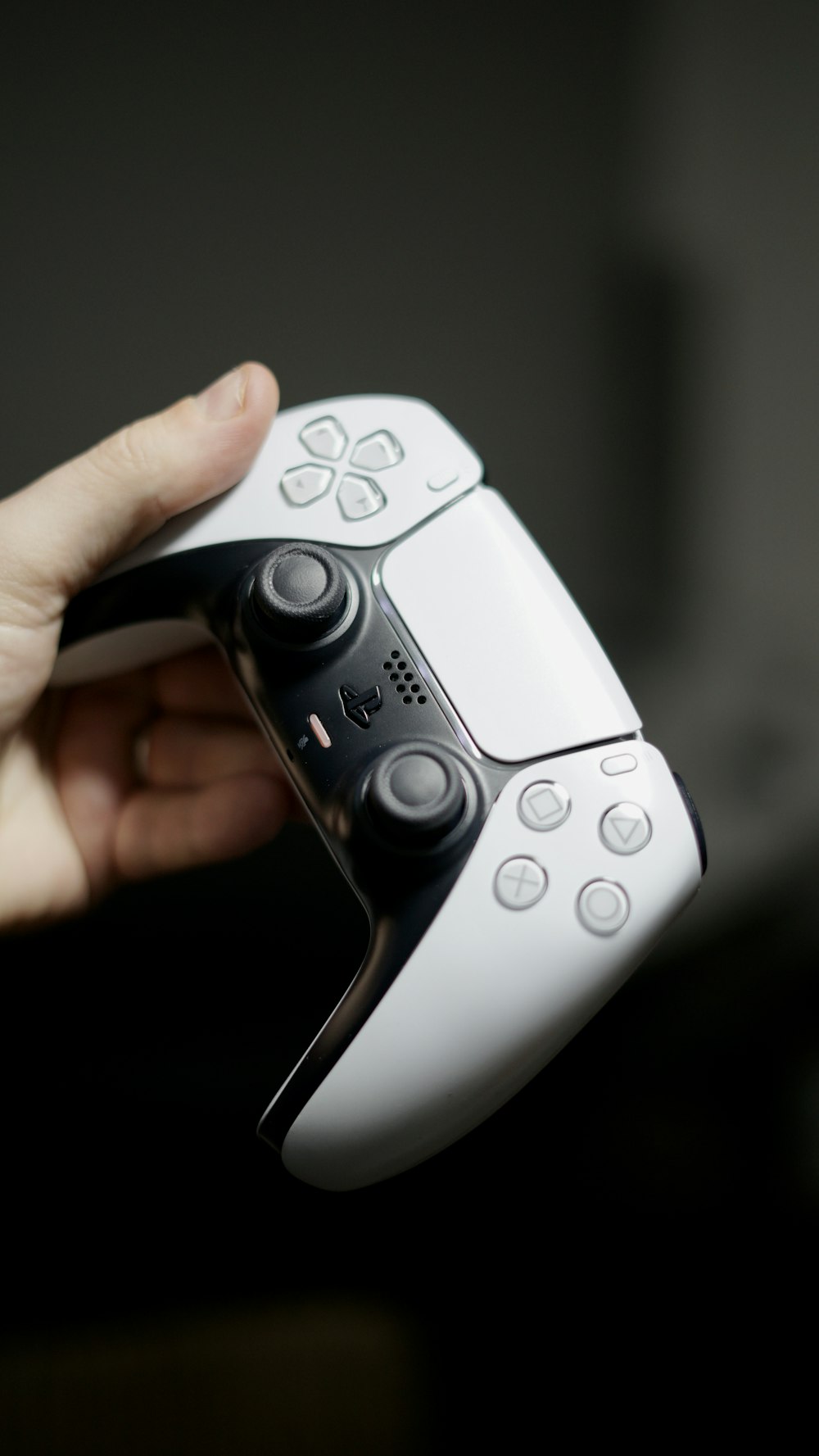 a person holding a video game controller in their hand