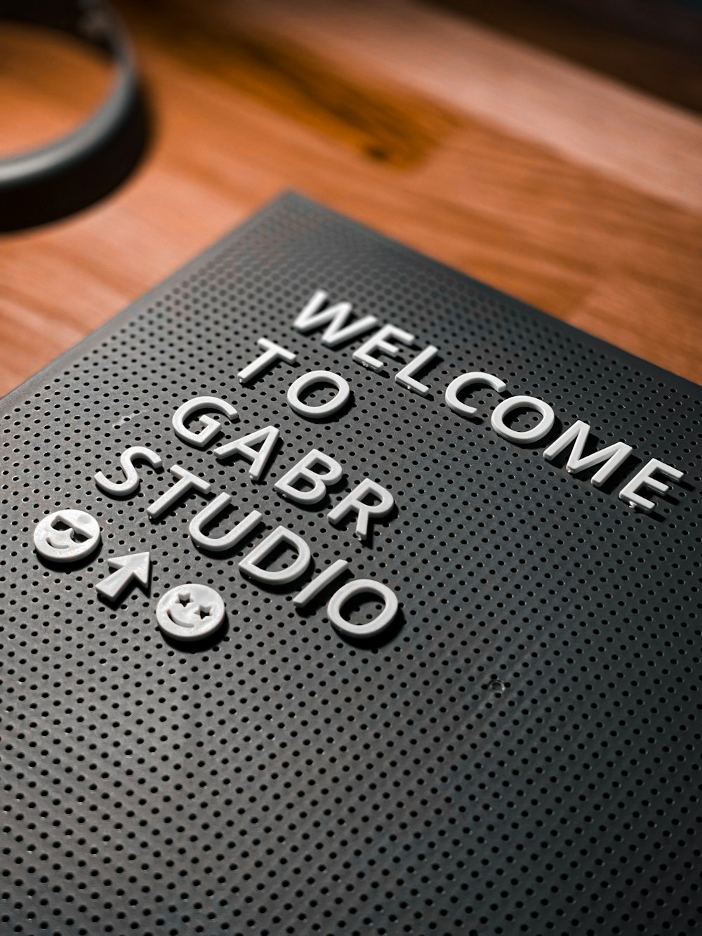a welcome to garb studio sign with a pair of headphones