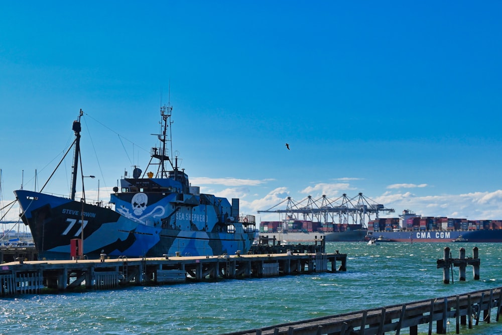 a large boat is docked at a pier