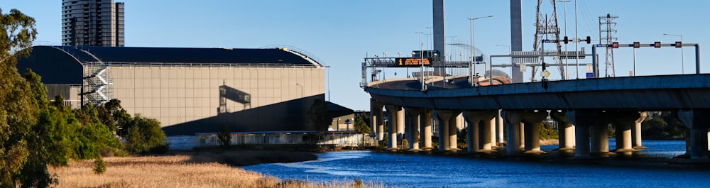 a bridge over a body of water next to a tall building