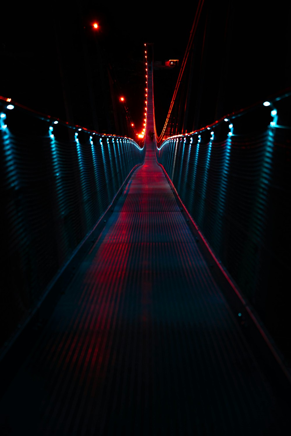 a long walkway lit up with red and blue lights