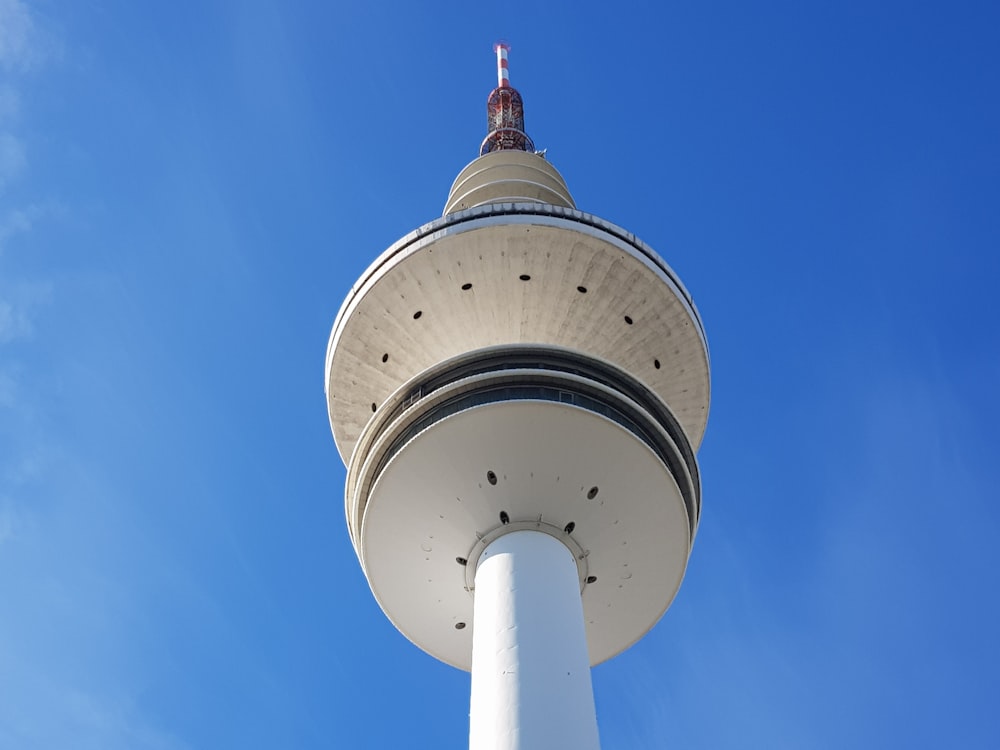 a tall white tower with a sky background