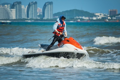 a man riding a jet ski on top of a body of water