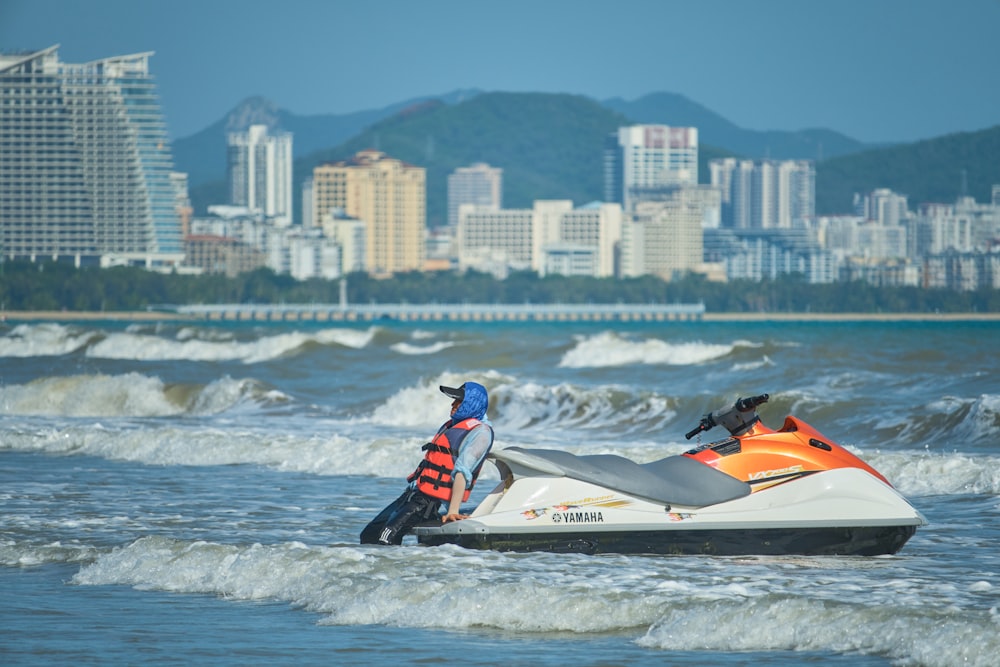 a man riding a jet ski on top of a body of water