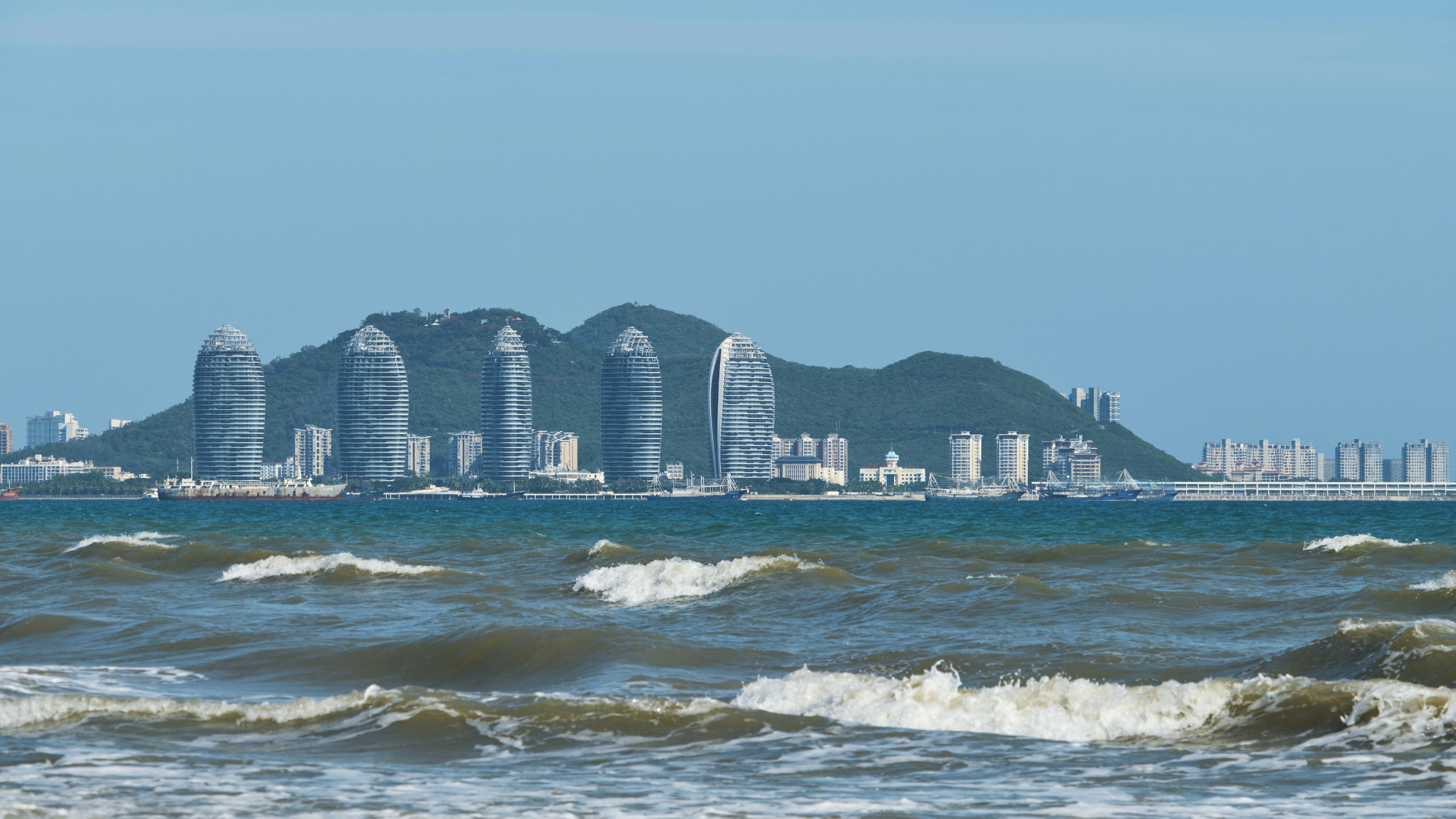 a large body of water with a city in the background