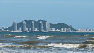 a large body of water with a city in the background