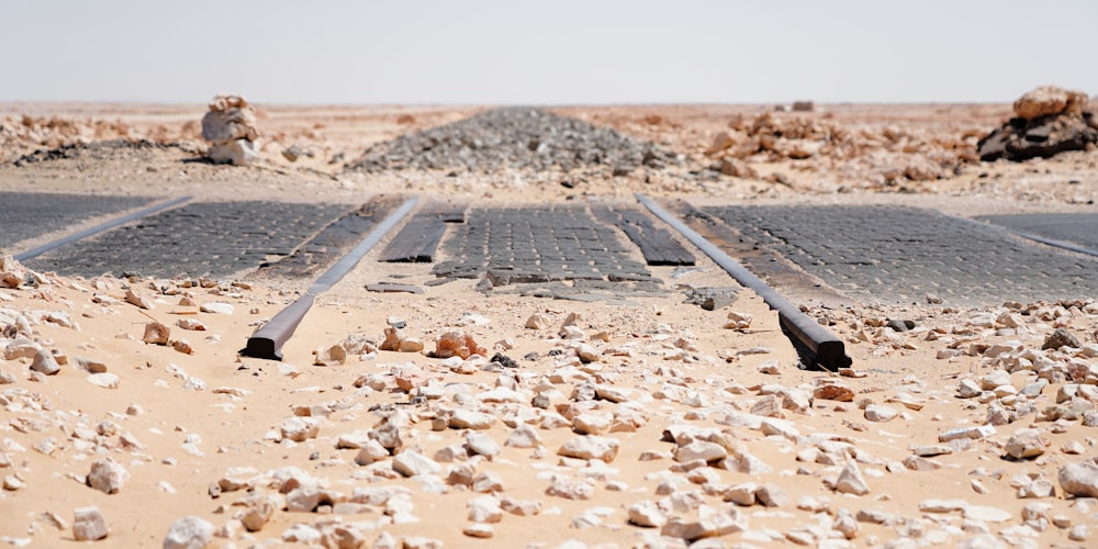 a couple of tracks in the middle of a desert