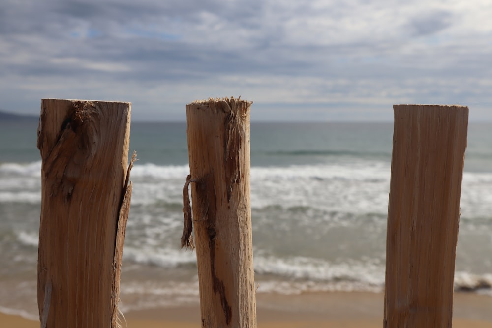 a close up of a wooden fence on a beach