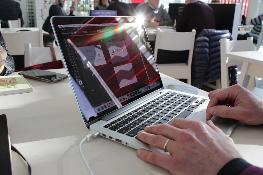 a person using a laptop computer on a table