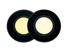 Two black vinyl records with light yellow labels placed side by side against a white background.