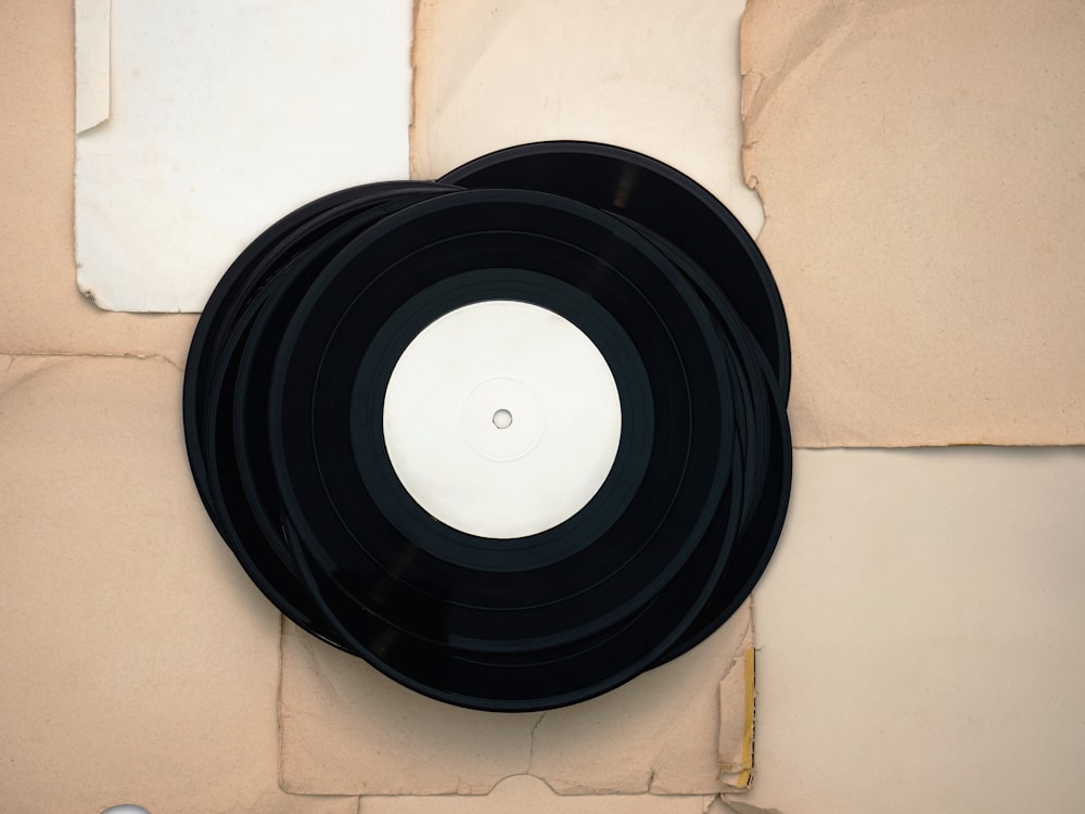 a pair of black records sitting on top of a table