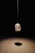 a rock hanging from a string in a dark room