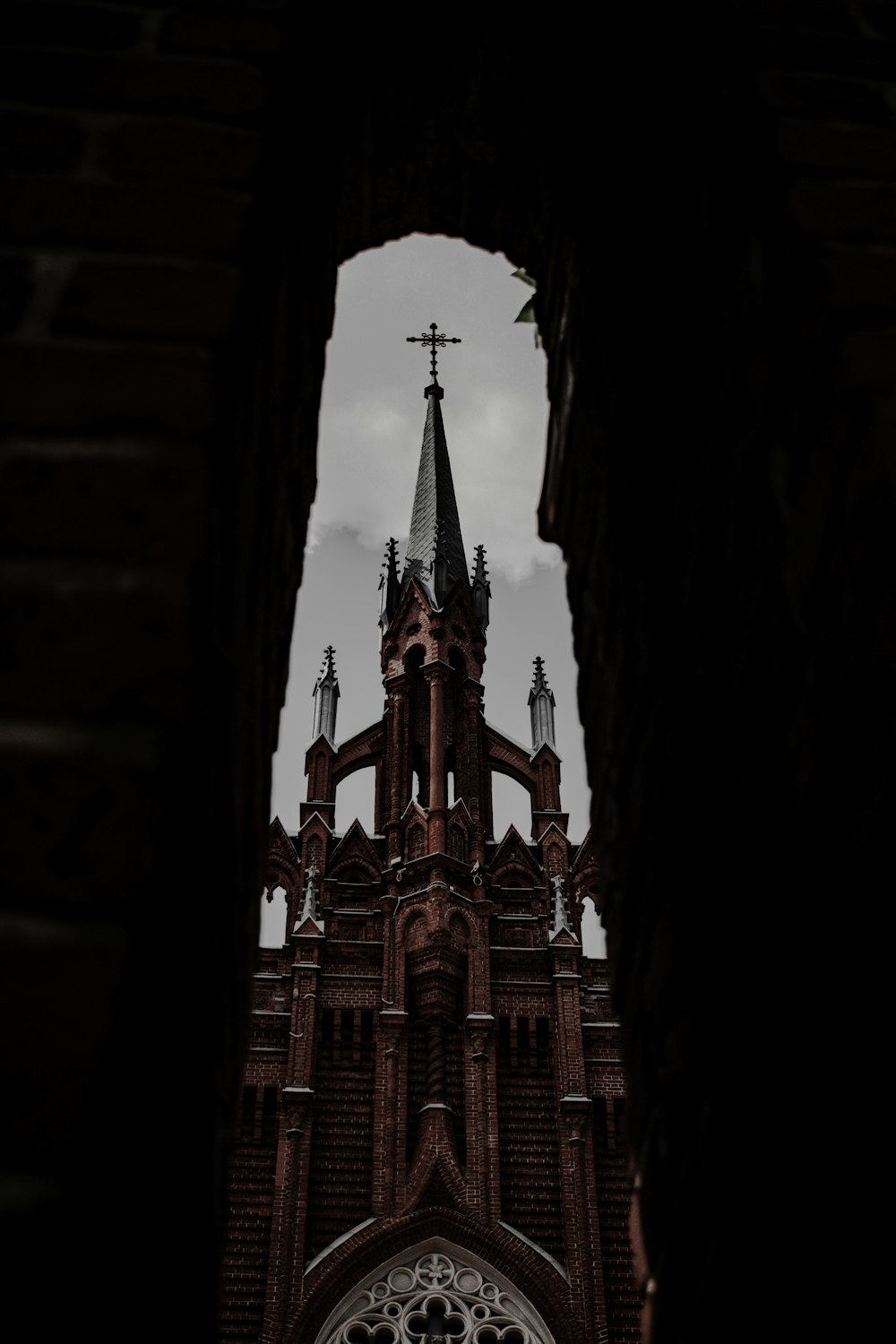 a church with a steeple seen through a hole in the wall