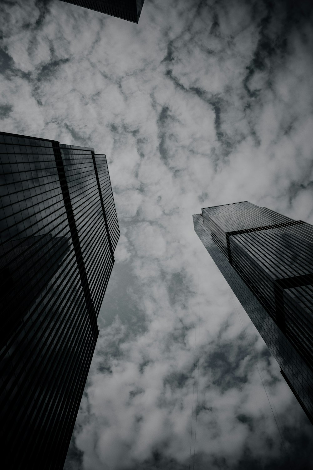 a black and white photo of two tall buildings