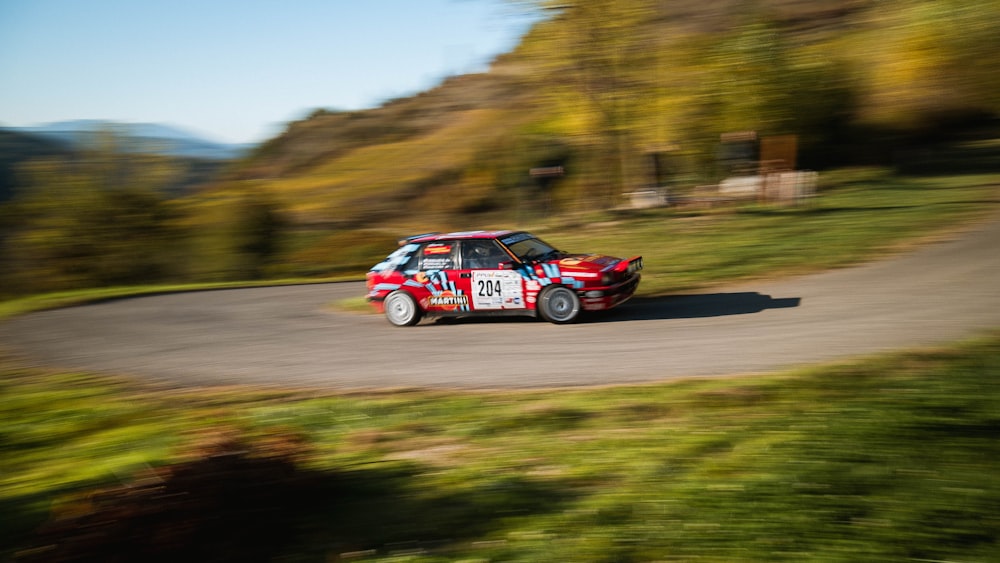 a small car driving down a winding road