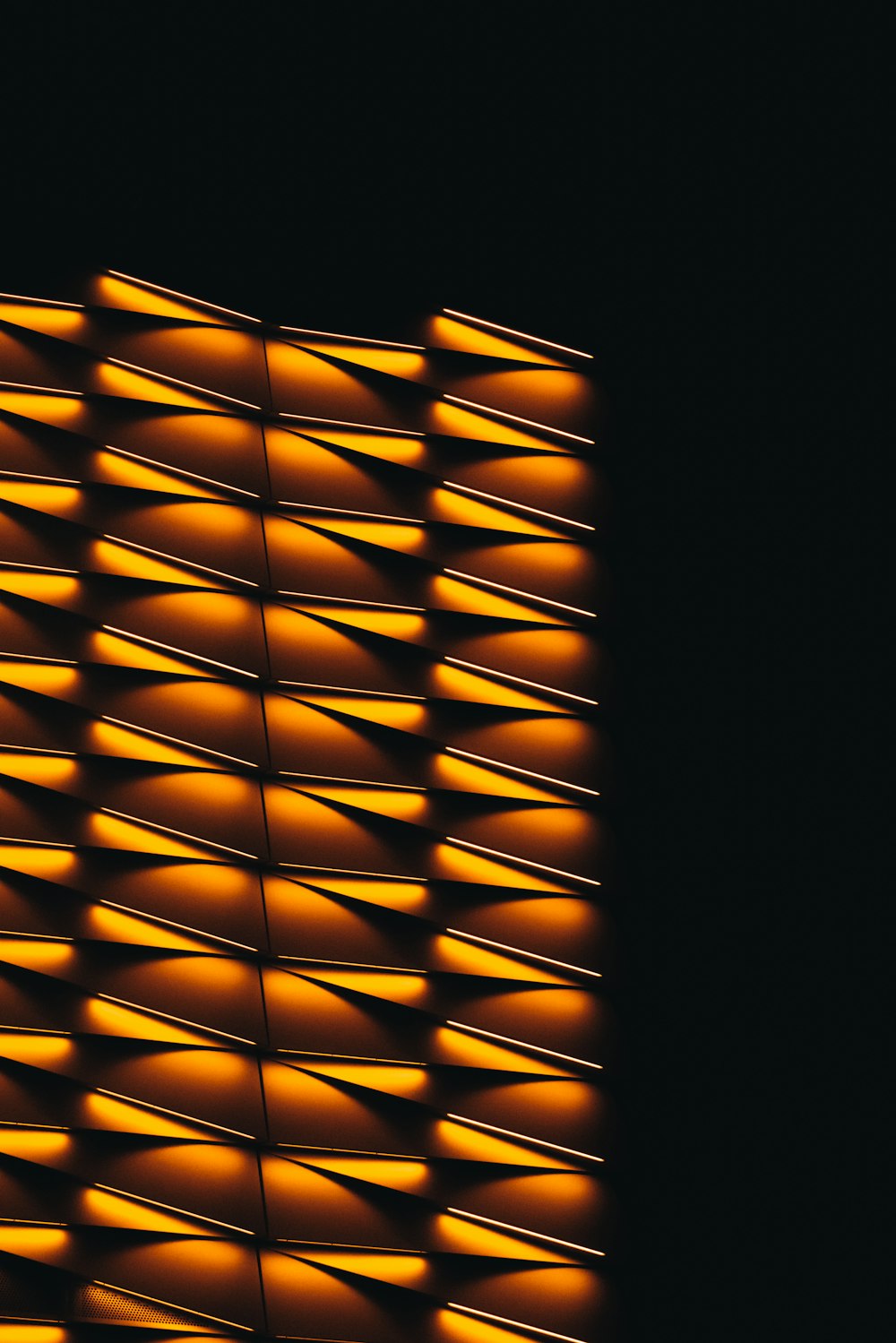 a close up of a wall made of orange lights