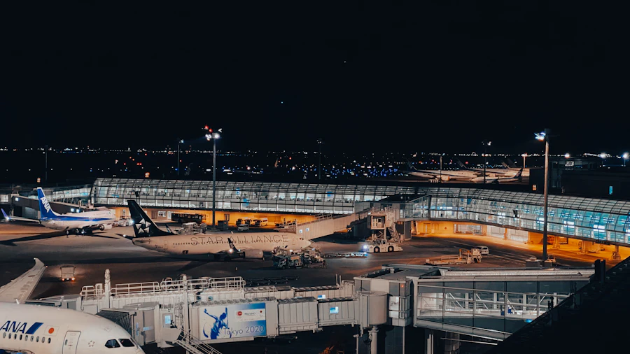 Aircraft parked on the apron at night under terminal floodlights