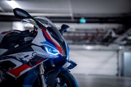 A sleek racing motorcycle with a bold, custom paint job shining under bright lights.