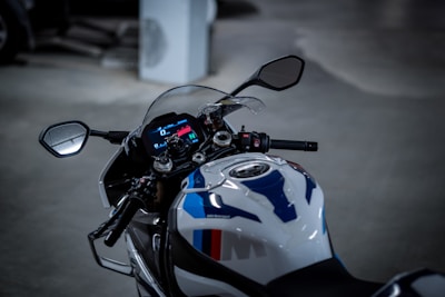 A close-up of a motorcycle's intricate dashboard illuminated by neon lights.