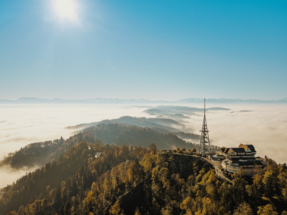 a tower on top of a mountain surrounded by fog