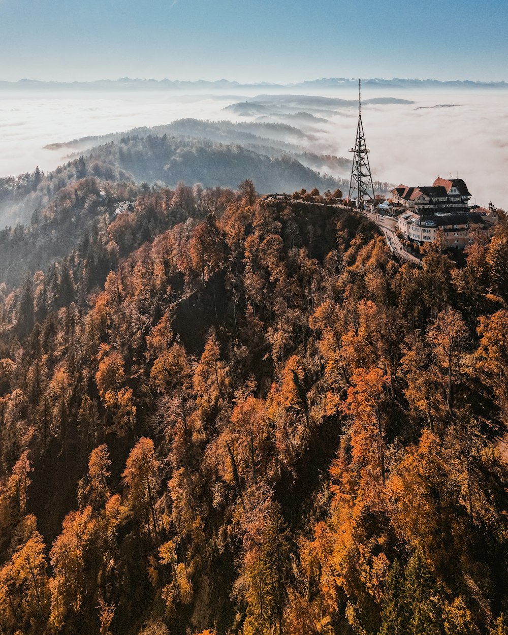 a tall tower sitting on top of a lush green hillside