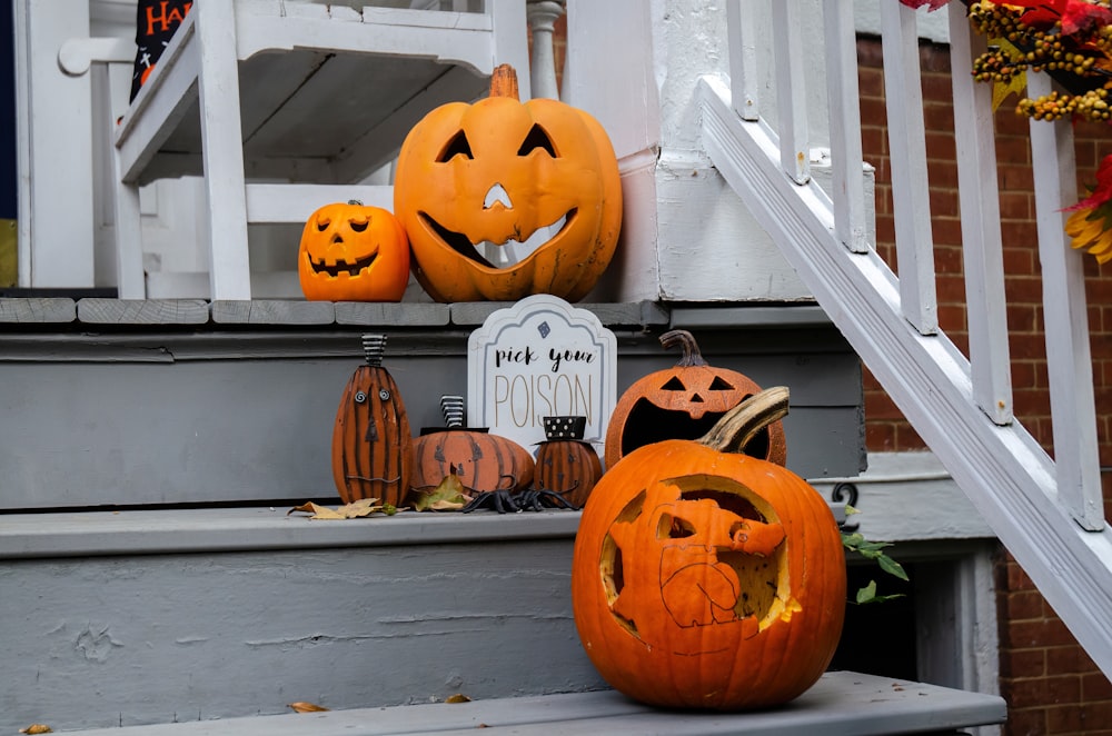 a couple of pumpkins that are sitting on a step