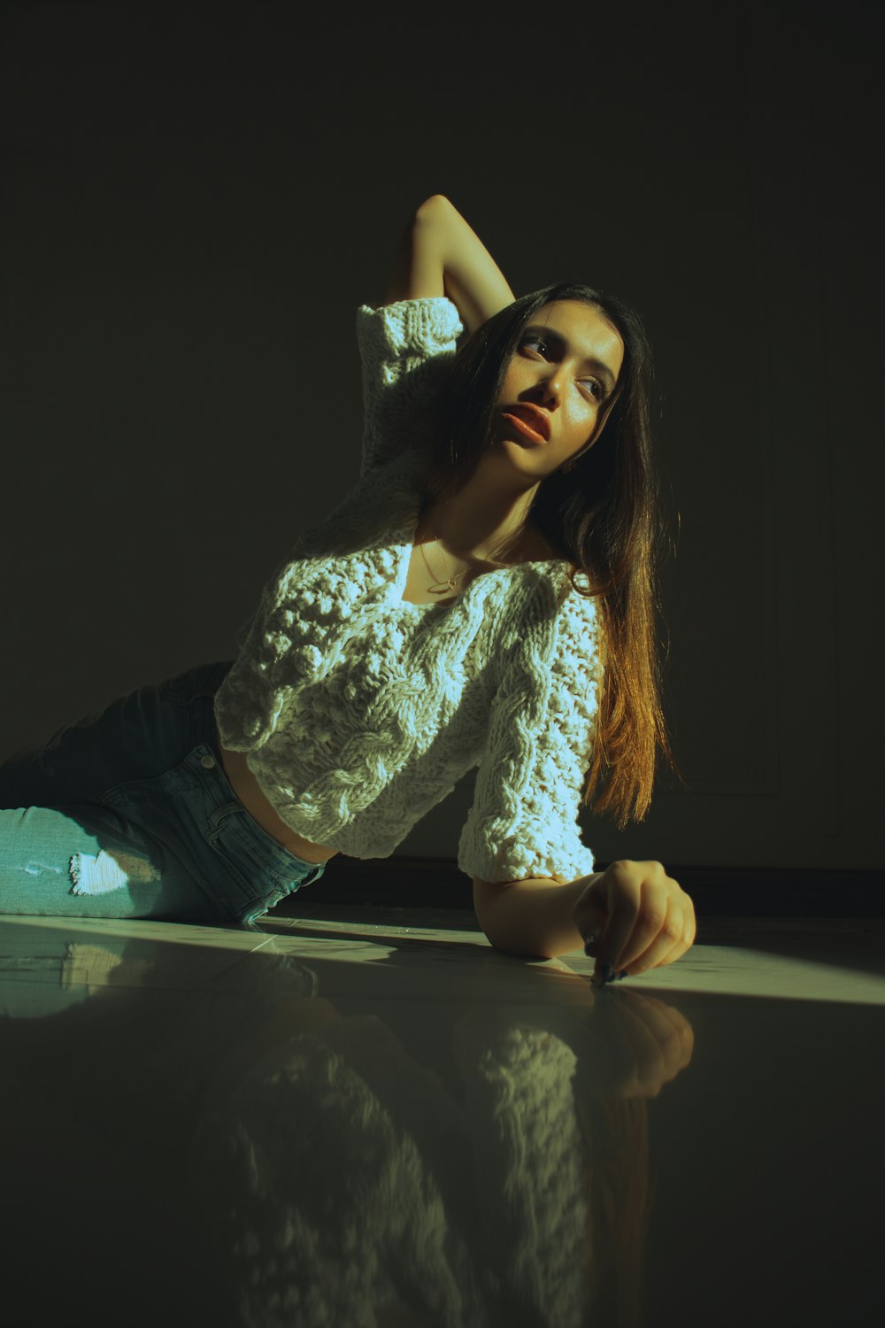 a woman is sitting on the floor posing for a picture