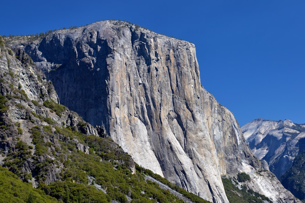 a large mountain with a very tall rock face