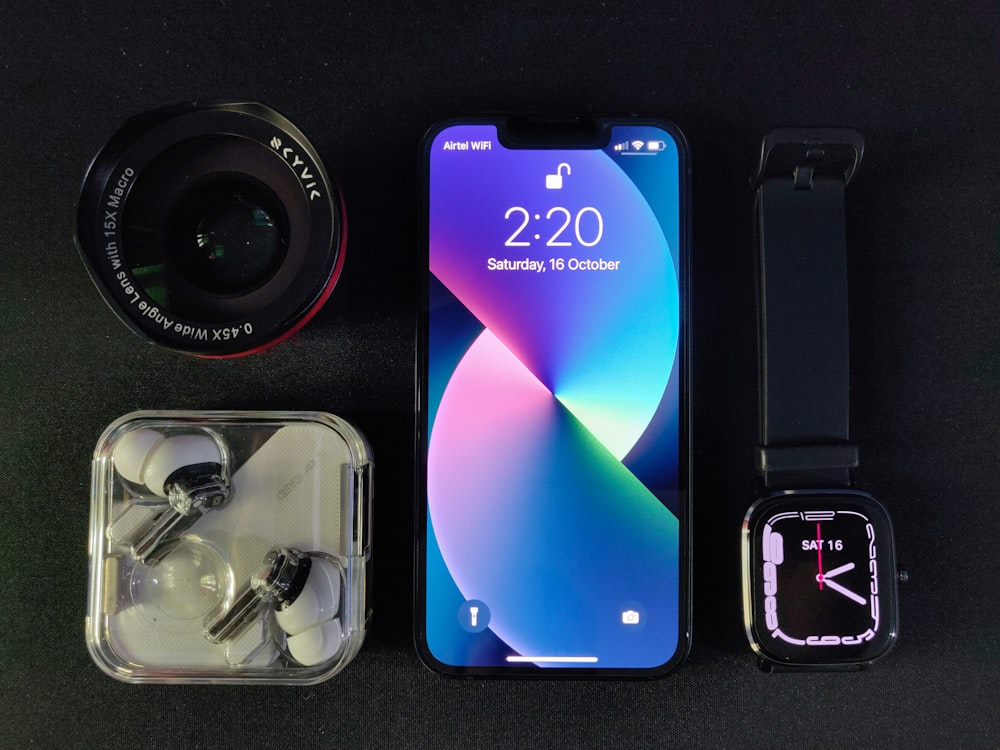 a cell phone sitting next to a couple of accessories