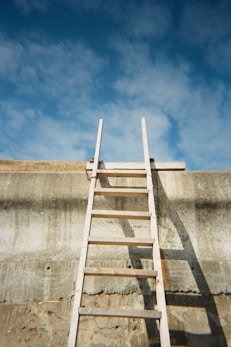 a ladder leaning up against a concrete wall