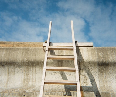 a ladder leaning up against a concrete wall