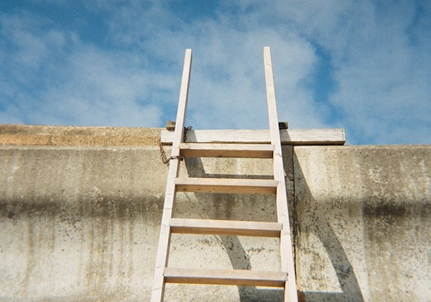 a ladder leaning up against a concrete wall