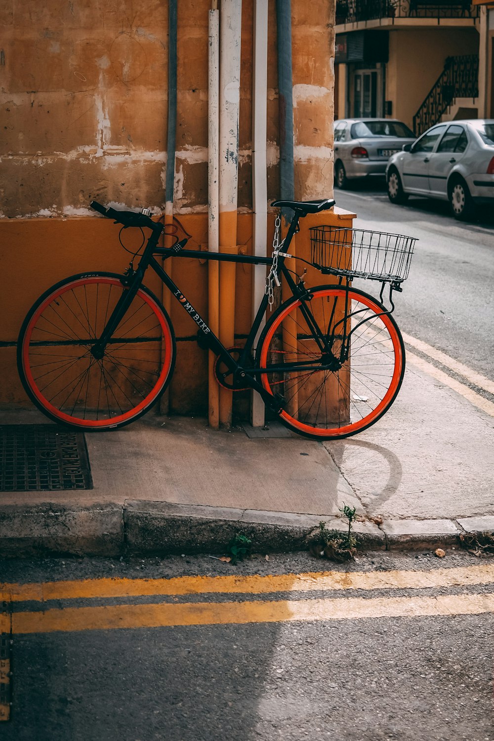 a bicycle parked next to a building on a city street