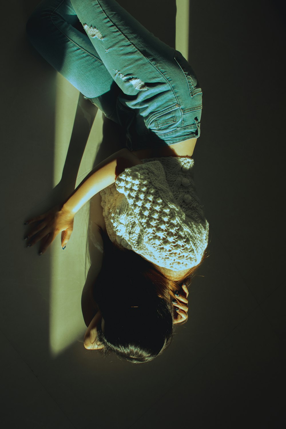 a woman laying on the floor with her head down